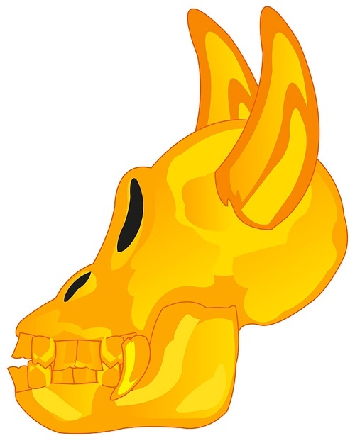 Golden skull of the crock with horn on white background is insulated