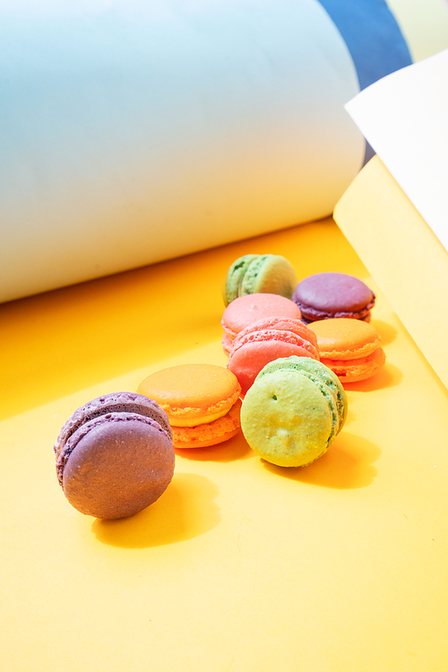 french cookies macaroons on gray and illuminating yellow background