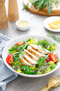 Chicken breast salad. Fresh vegetable salad with tomato, pepper, arugula and grilled chicken breast in bowl, healthy food.