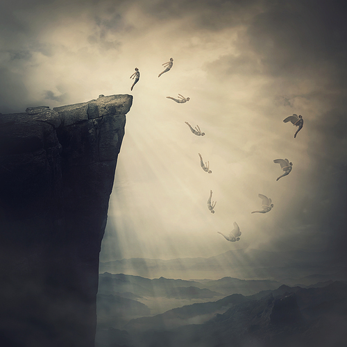 Surreal scene, determined man jumping from the edge of a cliff, fighting his fears, being confident the wings will unfold in flight. Free fall before flying. Self confidence concept, way to success