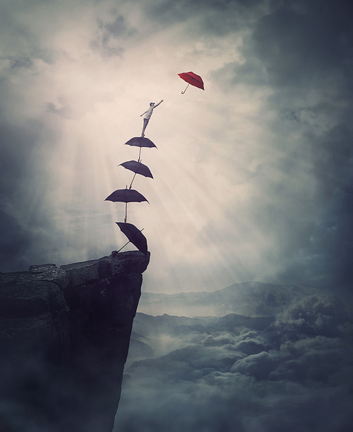 Surreal adventure, epic scene with a determined man climbing an improvised stairway of umbrellas, decided to reach a different one. Purposefulness and risk concept, on edge of a cliff, fighting fears