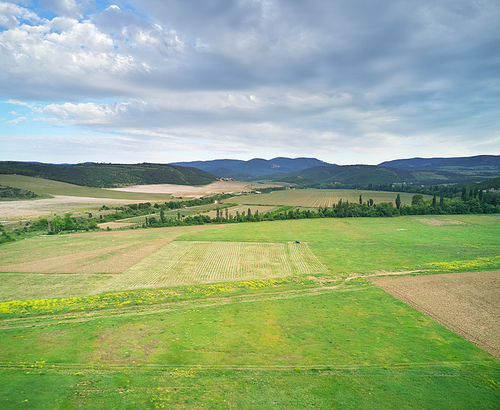 Scenic aerial view of beautiful landscape of the agrecultural valley and hills in the background. Nature composition.