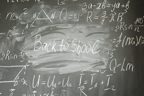 frame of formulas written in white chalk and back to school written words