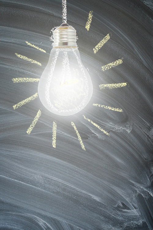 idea concept with one bright glowing light bulb on blackboard