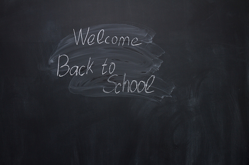 welocome back to school written with chalk words on blackboard