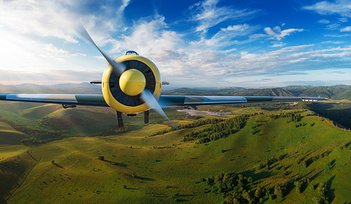 Small aircraft flying above in the blue sunset sky