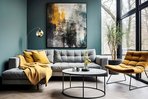 Yellow lounge chair and grey sofa with plaid against turquoise wall with art poster. Minimalist home interior design of modern living room.