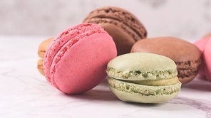 Macarons macaroons cookies dessert from France isolated on a white marble countertop.