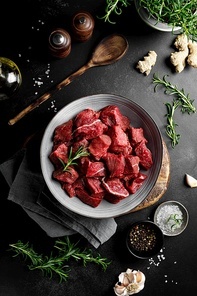 Beef meat entrecote sliced, raw beef meat fillet on black background, top view