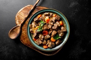 Beef meat goulash with carrot and onion, beef and carrot stew, top view