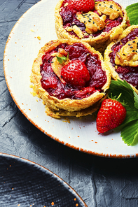 Strawberry shortcake pies on the plate.Tasty tartlets with fresh strawberries.Sweet dessert