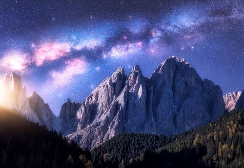 Milky Way and beautifull rocks at starry night in summer in Dolomites, Italy. Landscape with blue sky with stars, bright milky way, moonrise over high alpine rocky mountains, forest. Space. Nature