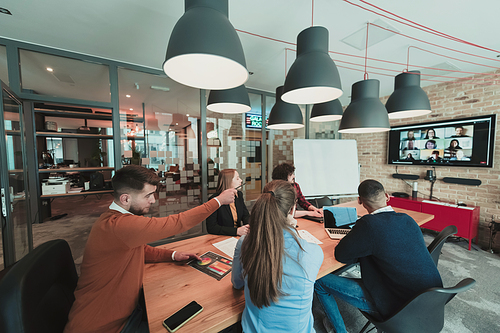 Successful team. Group of young multi-ethnic business people working and communicating together in creative office. Selective focus. High-quality photo