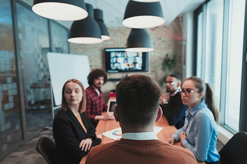 Successful team. Group of young multi-ethnic business people working and communicating together in creative office. Selective focus. High-quality photo