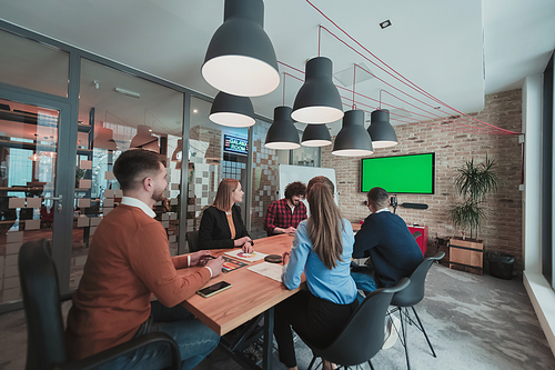 Successful team. Group of young multi-ethnic business people working and communicating together in creative office. Selective focus. High-quality photo