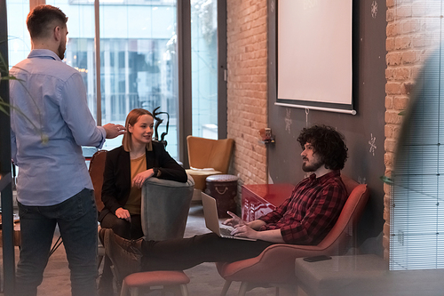 Successful team. Group of young businesspeople working and communicating together in creative office. Selective focus. High-quality photo