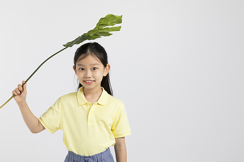어린이_트로피칼 잎 들고 있는 사진 이미지