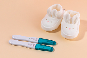 여성용품_임신테스트기와 아기 신발 사진 이미지