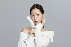 윈터뷰티_미소 지으며 손동작하는 여성 사진 이미지