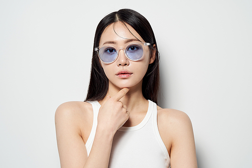 투명한 선글라스를 끼고 정면을 응시하는 동양인 여성