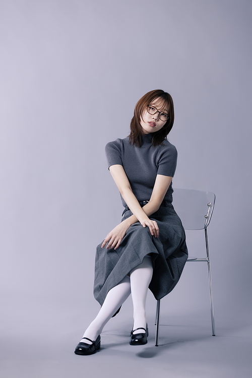 긱시크룩 스타일을 하고 의자에 걸터앉은 20대 한국인 여성
