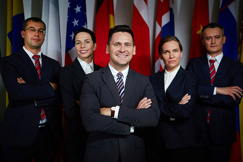Portrait of national business team standing with arms crossed