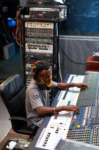 Musician or sound operator working in studio of sound