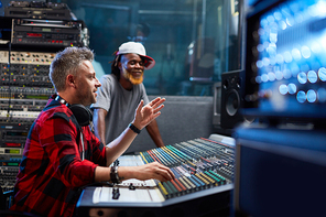 Sound-producer pointing at screen while showing his assistant level of sound