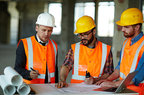 Team of modern constructors discussing sketch