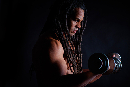 Strong bodybuilder with dreadlocks lifting barbell