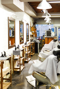 Barbershop room with professional equipment, armchairs and mirrors