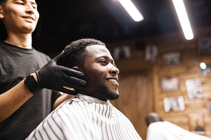 Smiling man sitting in barbershop