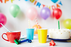 Decorated table with cups and cake on it