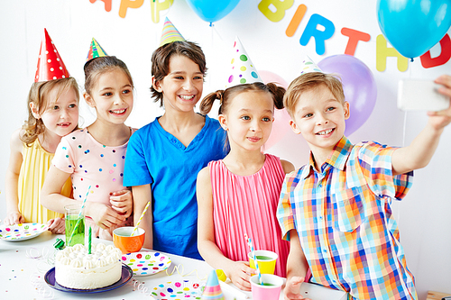 Group of children taking selfie at birthday party