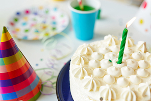 Birthday cake with candle on festive table