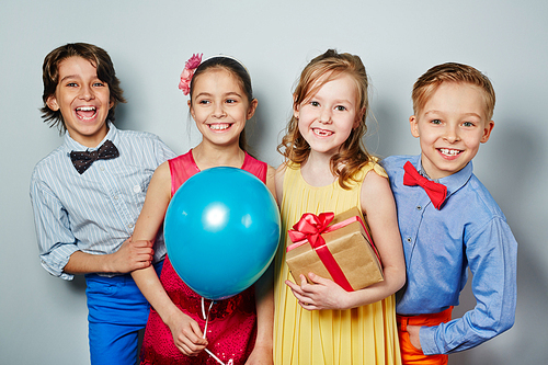 Cheerful kids in smart clothes having party