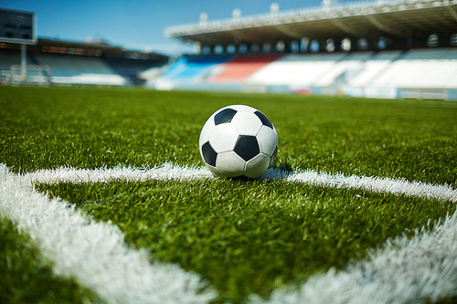 Close-up of soccer ball in th corner of pitch