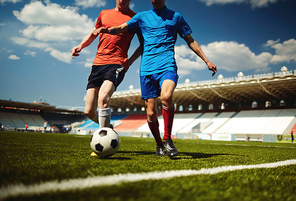 Two football players going to gather the ball