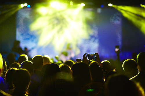 Crowd at concert and blurred stage lights