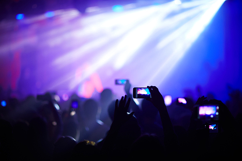 People photographing concert on a phone