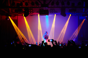 Concert crowd in front of bright stage lights