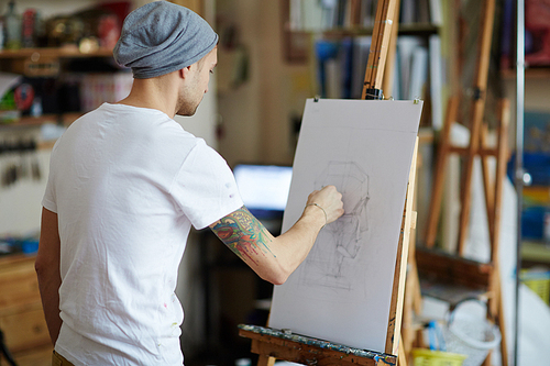 Young man drawing in art studio