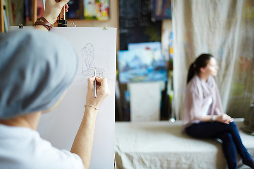 Student drawing a woman in studio