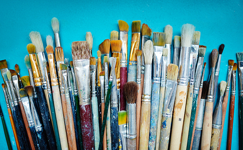 Group of paintbrushes on blue background