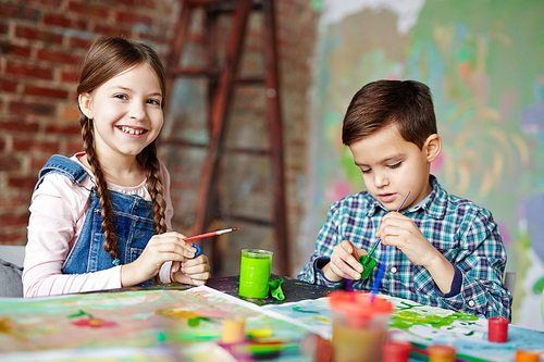 Little friends painting in kindergarten