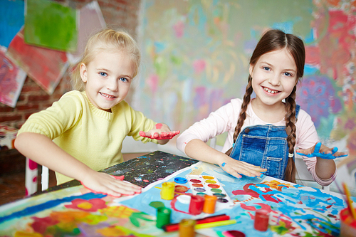 Cute schoolgirls having fun at drawing lesson