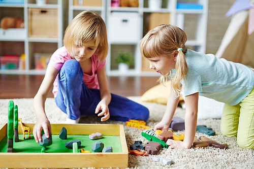 Little sisters playing zoo at home