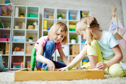 Adorable girls playing in kindergarten