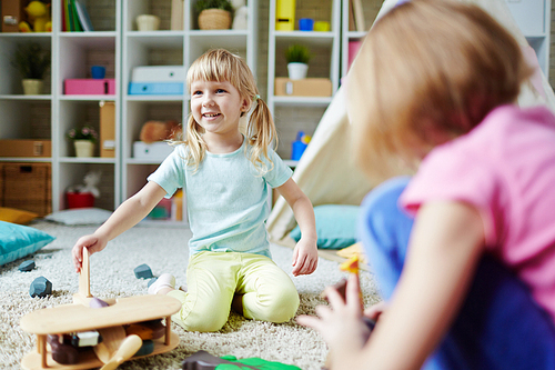 Funny girl playing in kindergarten