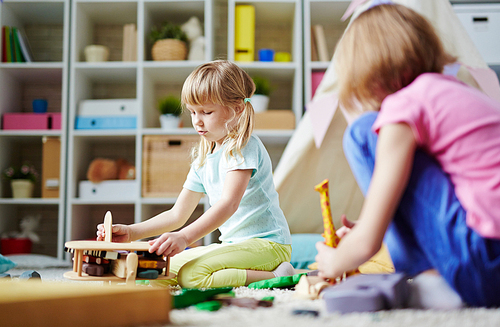 Small girls playing with toys